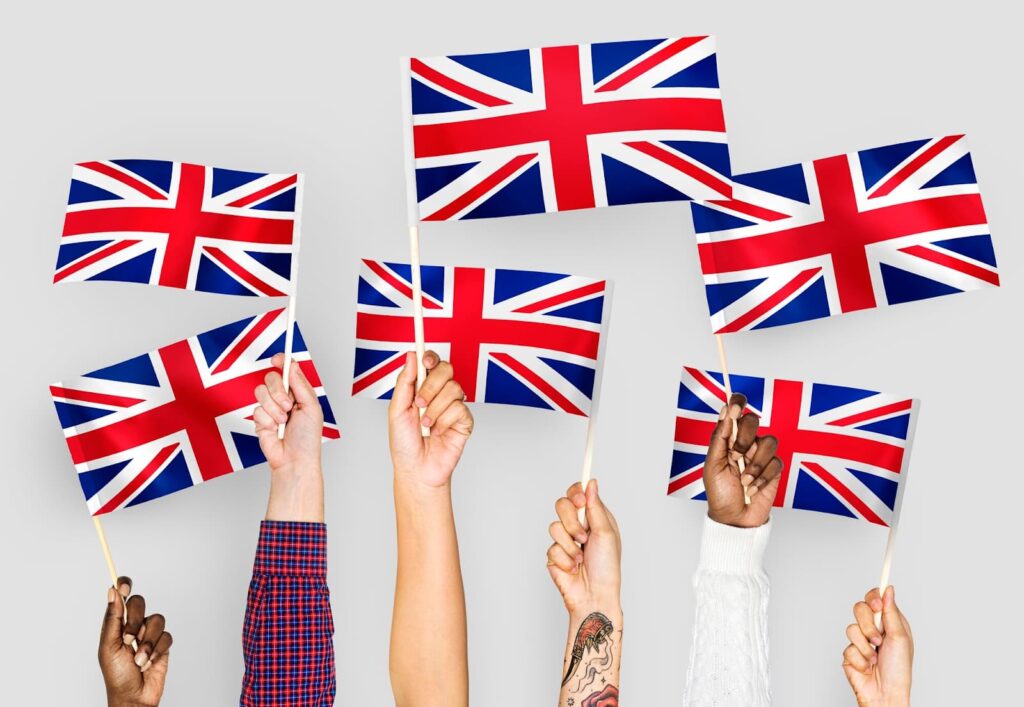Hands holding British flags
