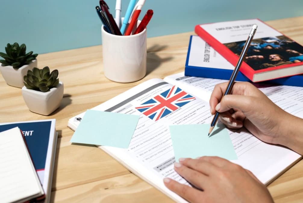 A person filling out a form with a British flag logo on it